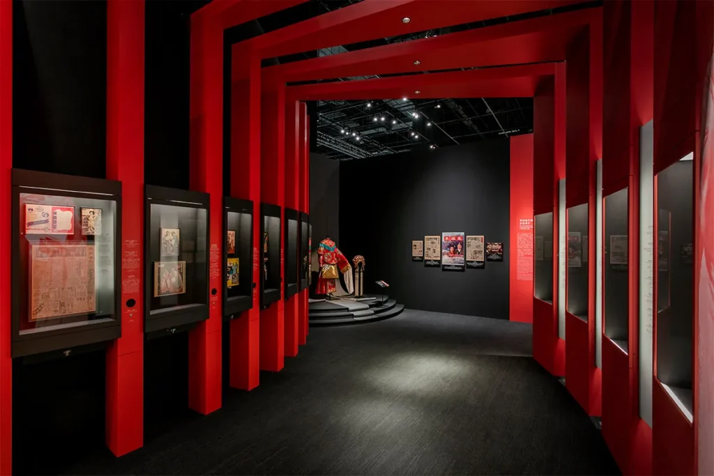 This image features the distinctive red portal frames and exhibits within the Hong Kong Heritage Museum, a project brought to fruition under the management of Rebel Arkitekt, showcasing Hong Kong's rich pop culture heritage.