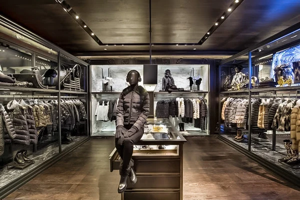 Luxurious ski clothing shop interior with mannequin in padded outfit and a selection of winter apparel.