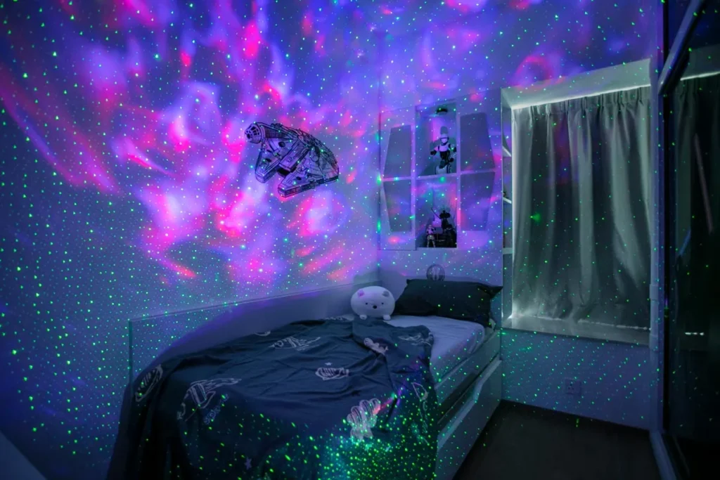 Enchanting space-themed bedroom at night with cosmic wall projections and ambient lighting, highlighting Rebel Arkitekt's playful yet thoughtful design for an immersive interstellar experience.