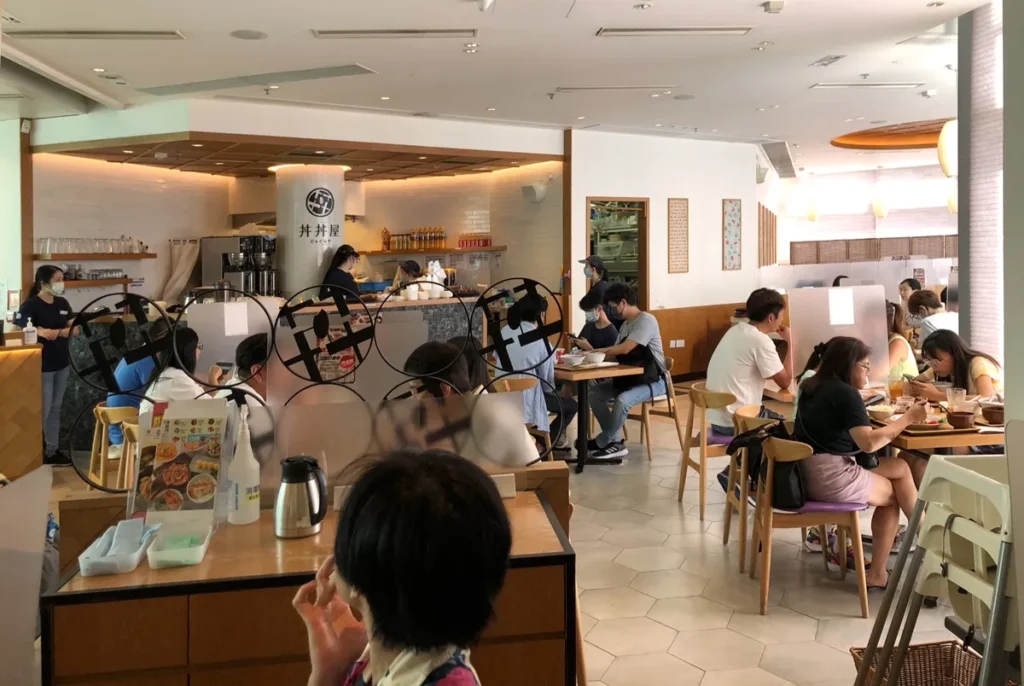 Casual dining atmosphere in DONDONYA x TORIKAI with patrons enjoying their meal, prior to the Rebel Arkitekt's innovative redesign.