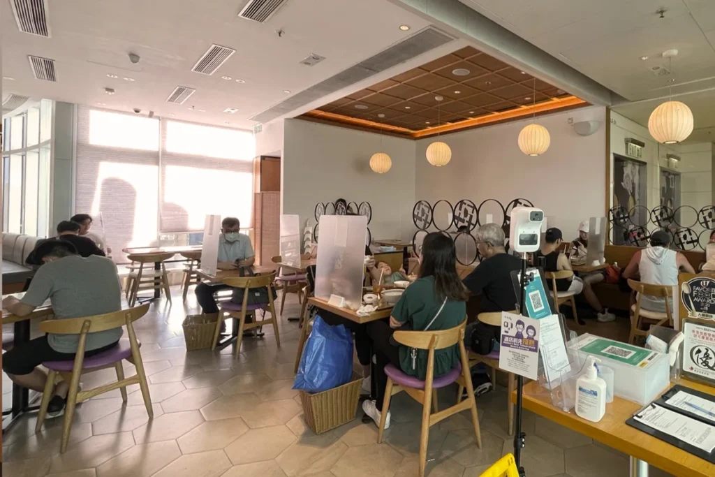 A bustling DONDONYA x TORIKAI dining scene with natural light, showing the restaurant's layout prior to Rebel Arkitekt's renovation project.