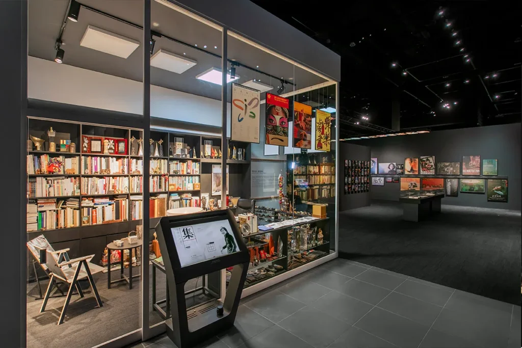 Cultural exhibit showcasing Dr. Kan's contributions to Hong Kong entertainment with a display of personal artifacts, awards, and a rich collection of literature.