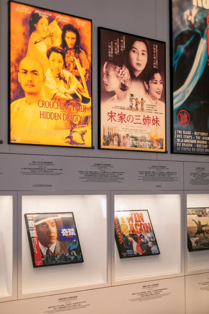 Wall display showcasing a collection of iconic film posters from influential Hong Kong cinema