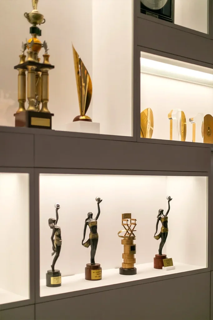 A curated display of awards and trophies commemorating cinematic achievements, highlighting the excellence and international acclaim of Hong Kong’s film industry.