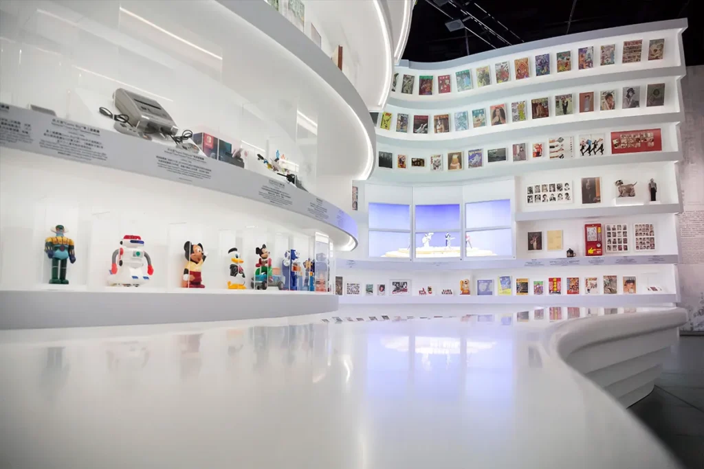 A pristine, bright interior space where curving white shelves display a nostalgic collection of toys and figurines, leading the eye upwards to framed visuals and artifacts, reflecting the heritage and storytelling preserved through the adept coordination of Rebel's project management.