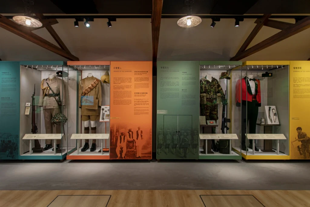 Garrison uniforms exhibit at the Hong Kong Museum of Coastal Defence, showcasing the historical attire and roles of various military units.