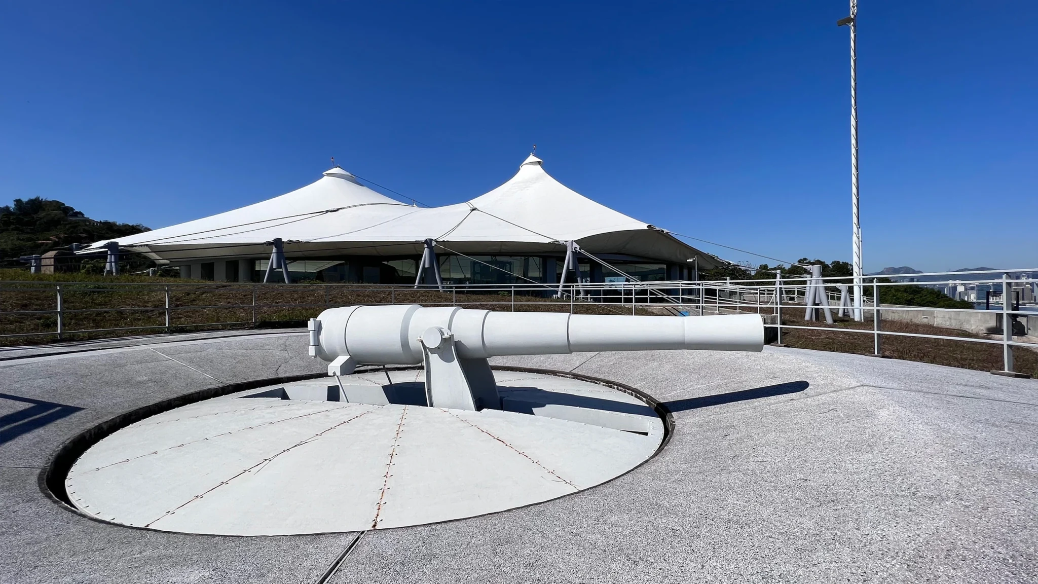 Historic rooftop coastal defense gun at the Hong Kong Museum, showcasing strategic defense innovations with a panoramic view