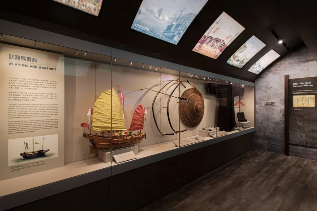 Weapons and Warships exhibit at the Hong Kong Museum of Coastal Defence, displaying model ships and traditional weaponry from Hong Kong’s maritime history.