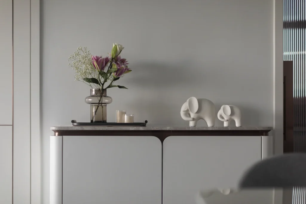 bespoke cabinet with floral arrangement and decorative figurines