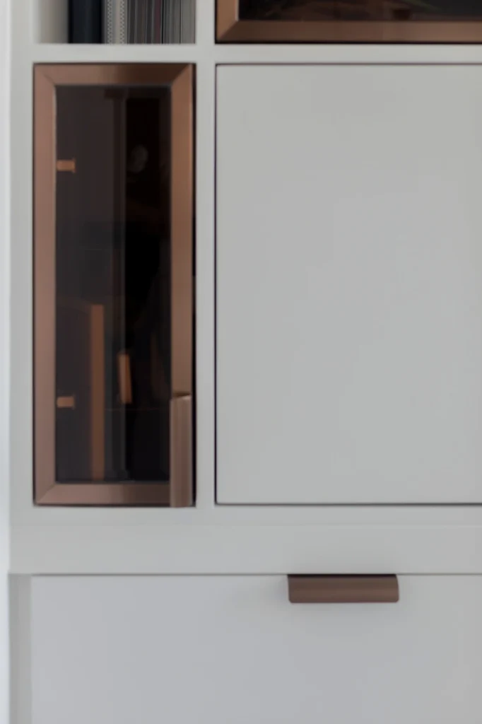 close-up of storage cabinet with smoked glass and bronze accents