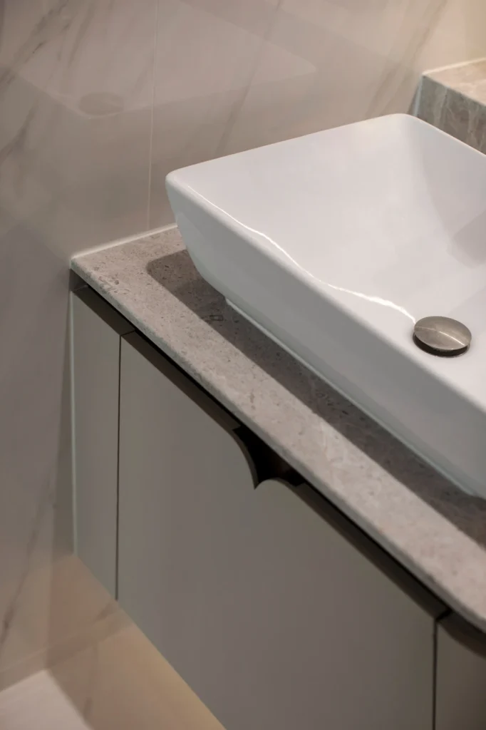 close-up of vanity with marble countertop and sink detail