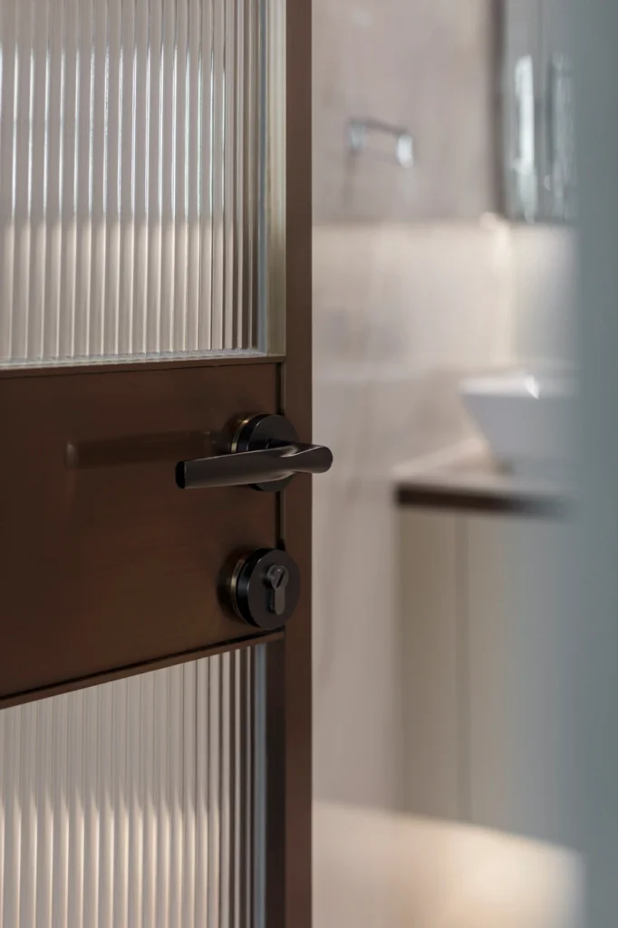 close-up of glass door with sleek black handle